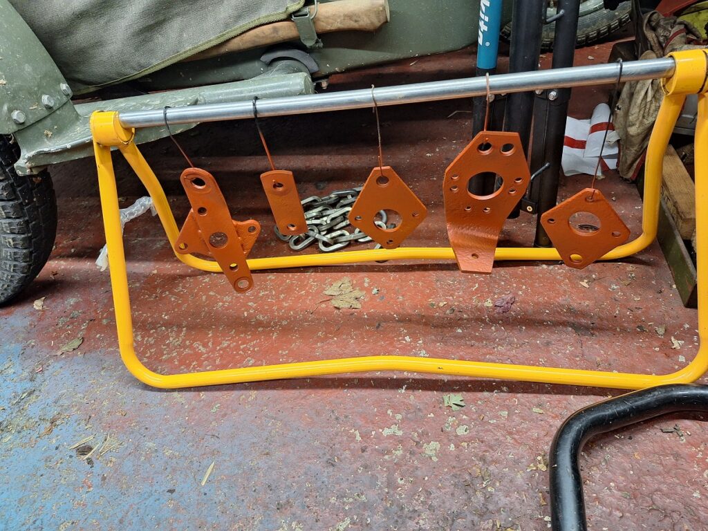 Rear suspension brackets in primer